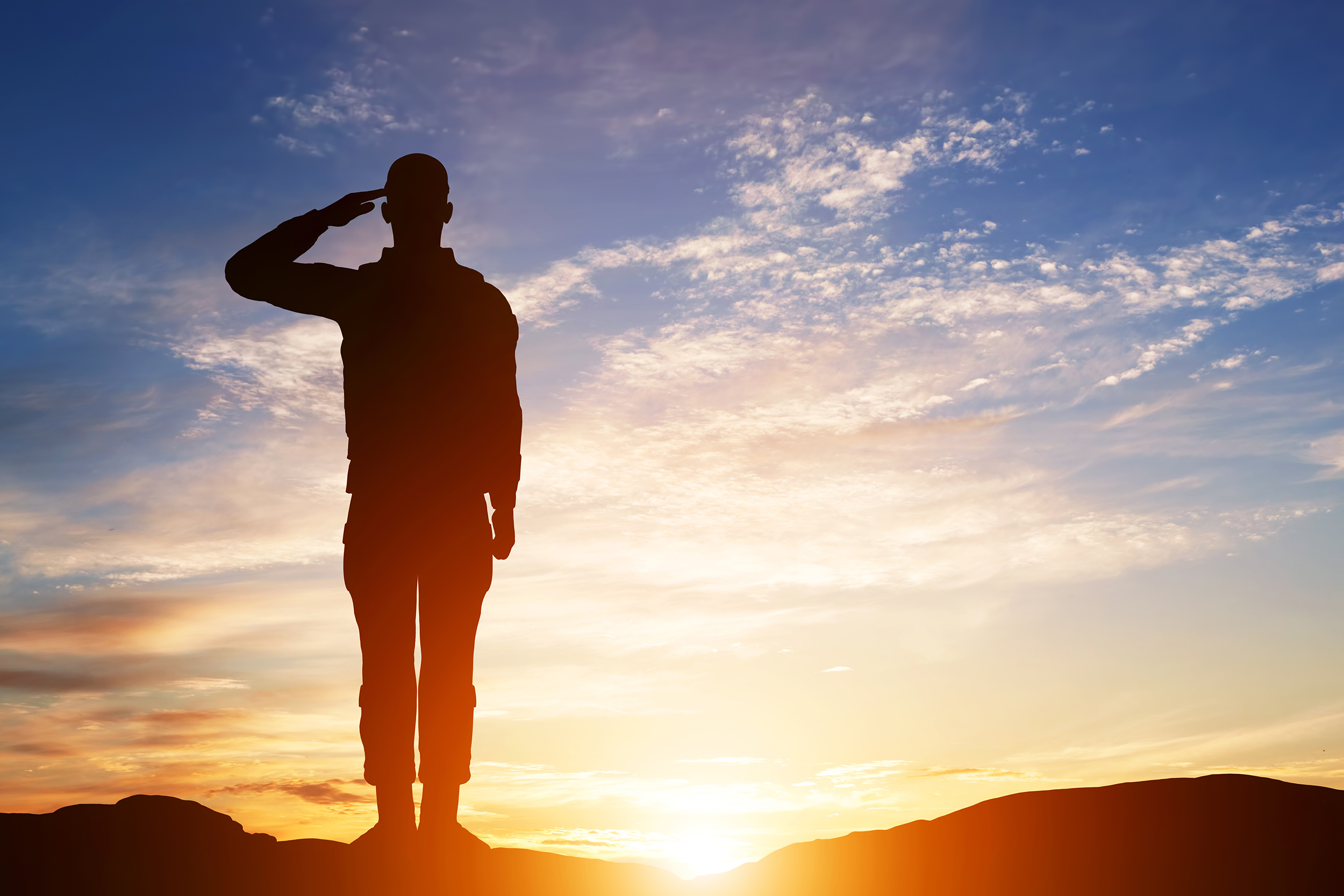 Soldier salute. Silhouette on sunset sky. War, army, military, guard concept.